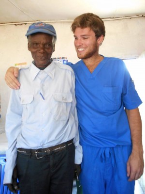 Chris in scrubs during his medical work experience in Tanzania